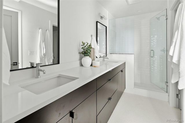 a bathroom with a double vanity sink and mirror