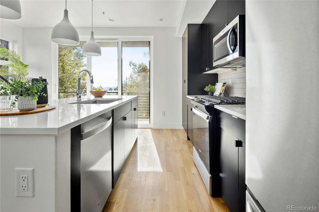 a kitchen with stainless steel appliances granite countertop a sink and cabinets