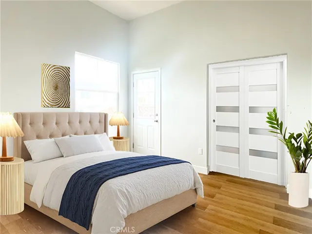 a bedroom with a bed and wooden floor