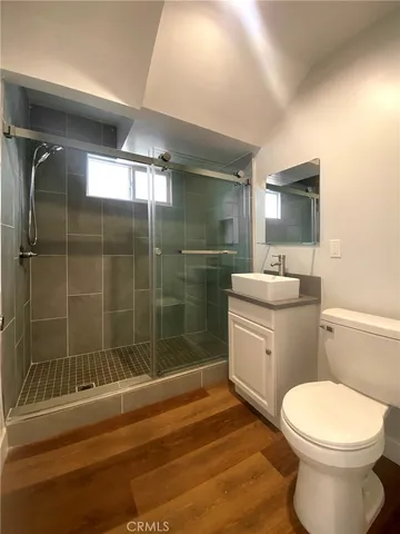 a bathroom with a toilet a sink and shower