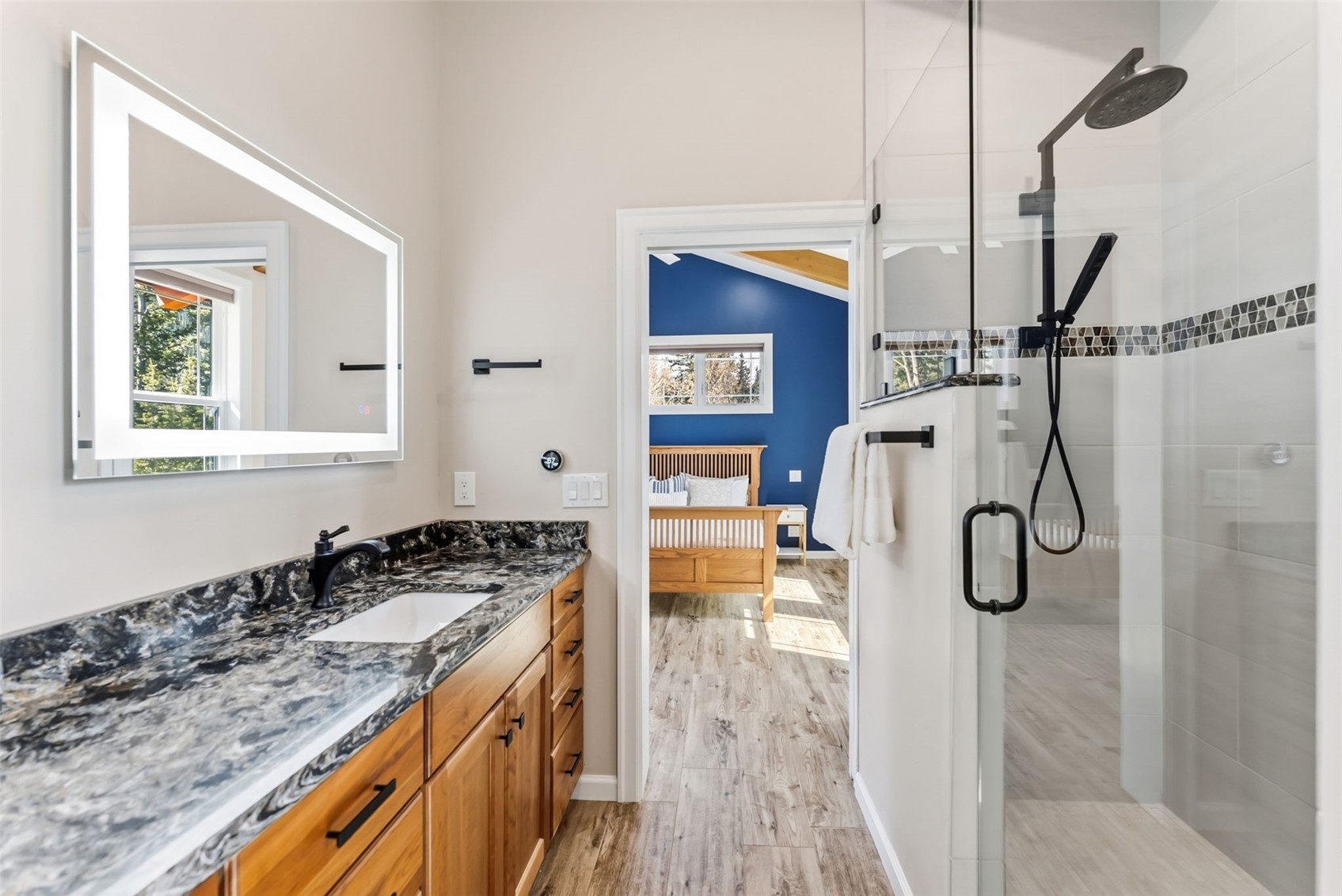 1227 Edgewood Road Alma, CO 80420 - Photo 15 of 40 a bathroom with a granite countertop sink a mirror and shower