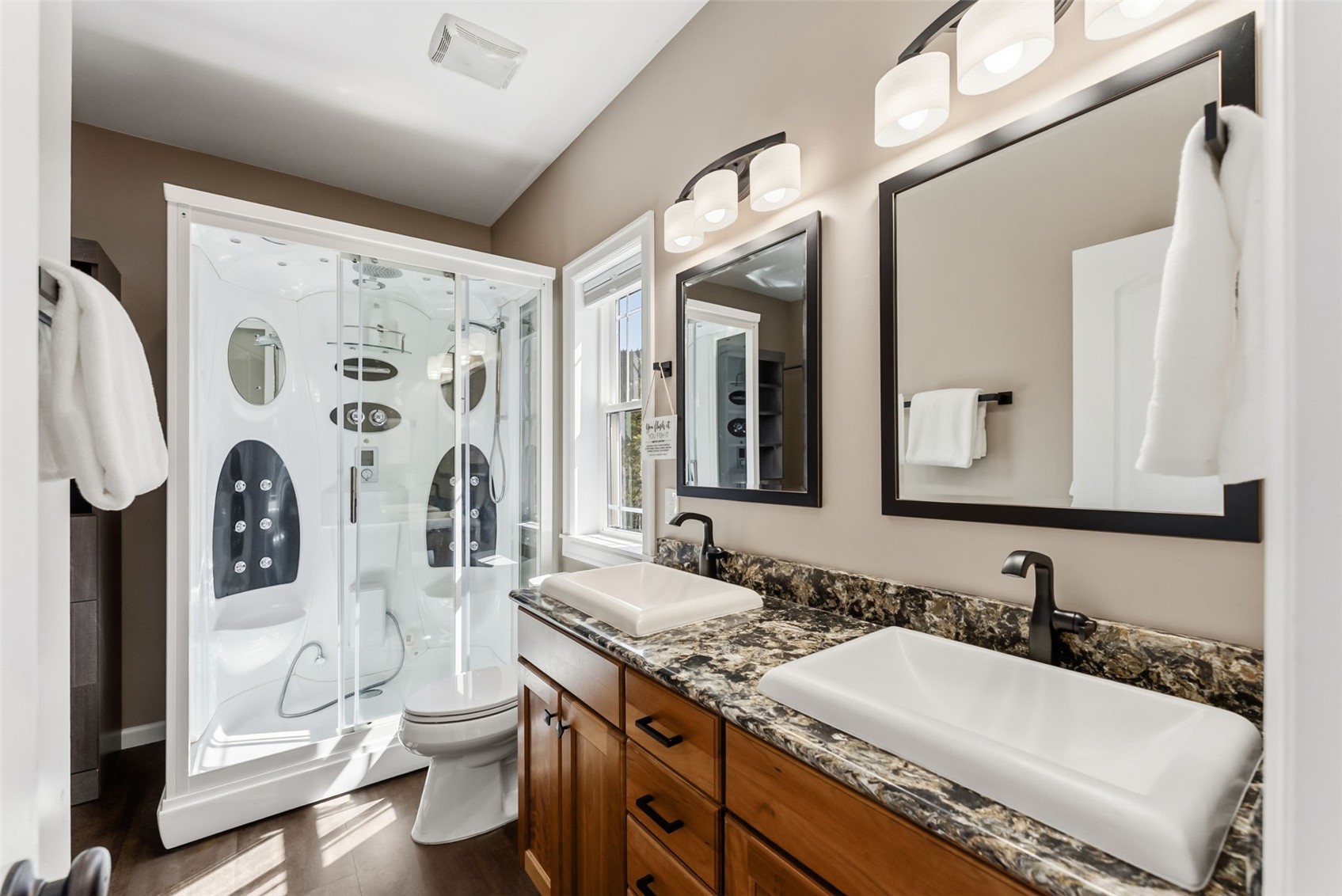 1227 Edgewood Road Alma, CO 80420 - Photo 26 of 40 a bathroom with a granite countertop sink mirror vanity and toilet