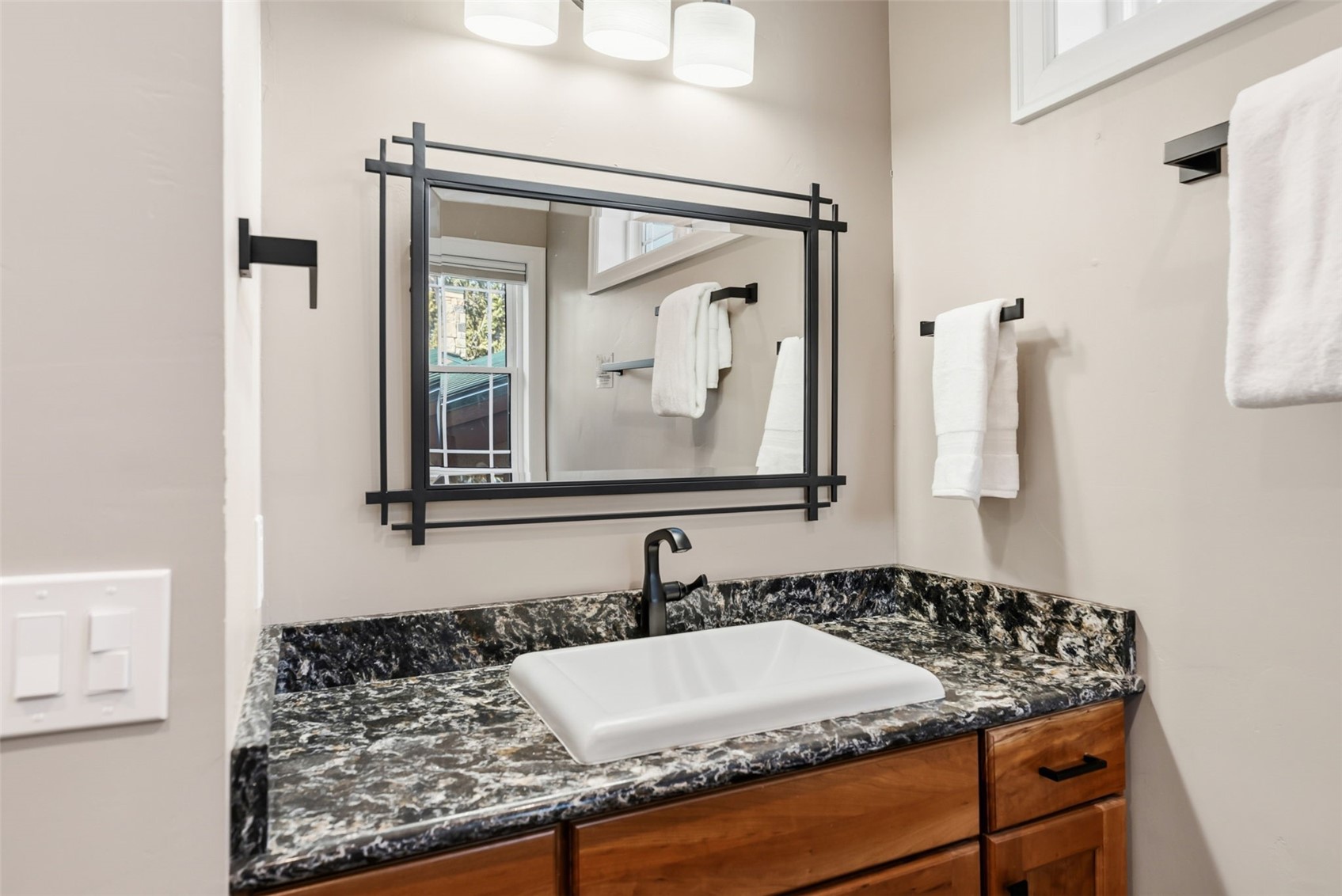 1227 Edgewood Road Alma, CO 80420 - Photo 29 of 40 a bathroom with a granite countertop sink and a mirror