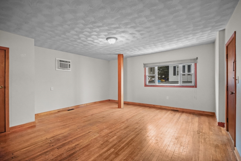 554 Third Street Fall River, MA 02721 - Photo 5 of 33 a view of an empty room with wooden floor and a window