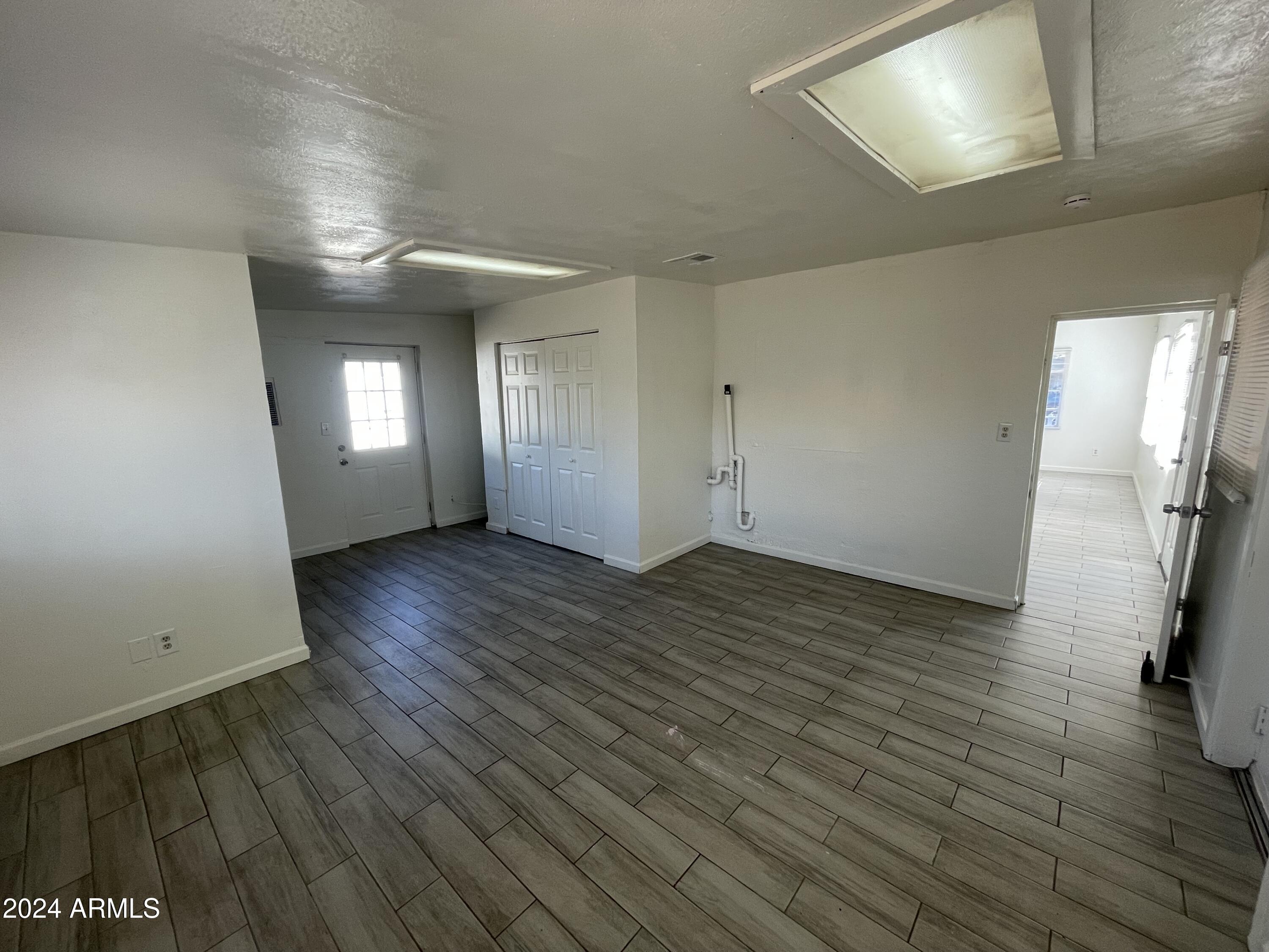 7210 North 55th Drive Glendale, AZ 85301 - Photo 12 of 13 wooden floor in an empty room with a window
