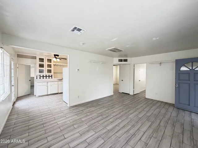 wooden floor in an empty room with a window