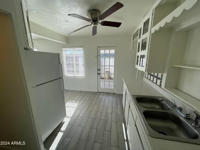 a kitchen with a refrigerator and a sink