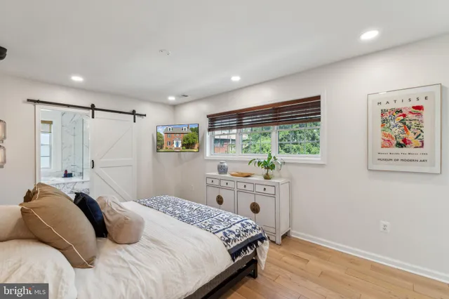 a bedroom with a large bed and a window