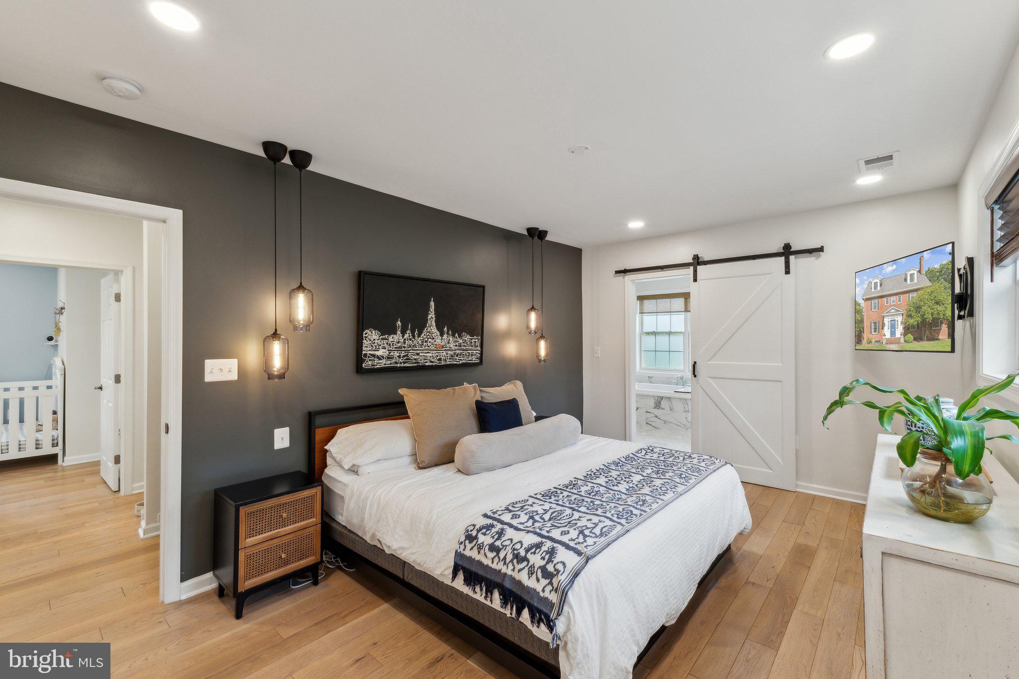 7401 Blair Road Northwest Washington, DC 20012 - Photo 19 of 42 a bedroom with a bed and a chandelier