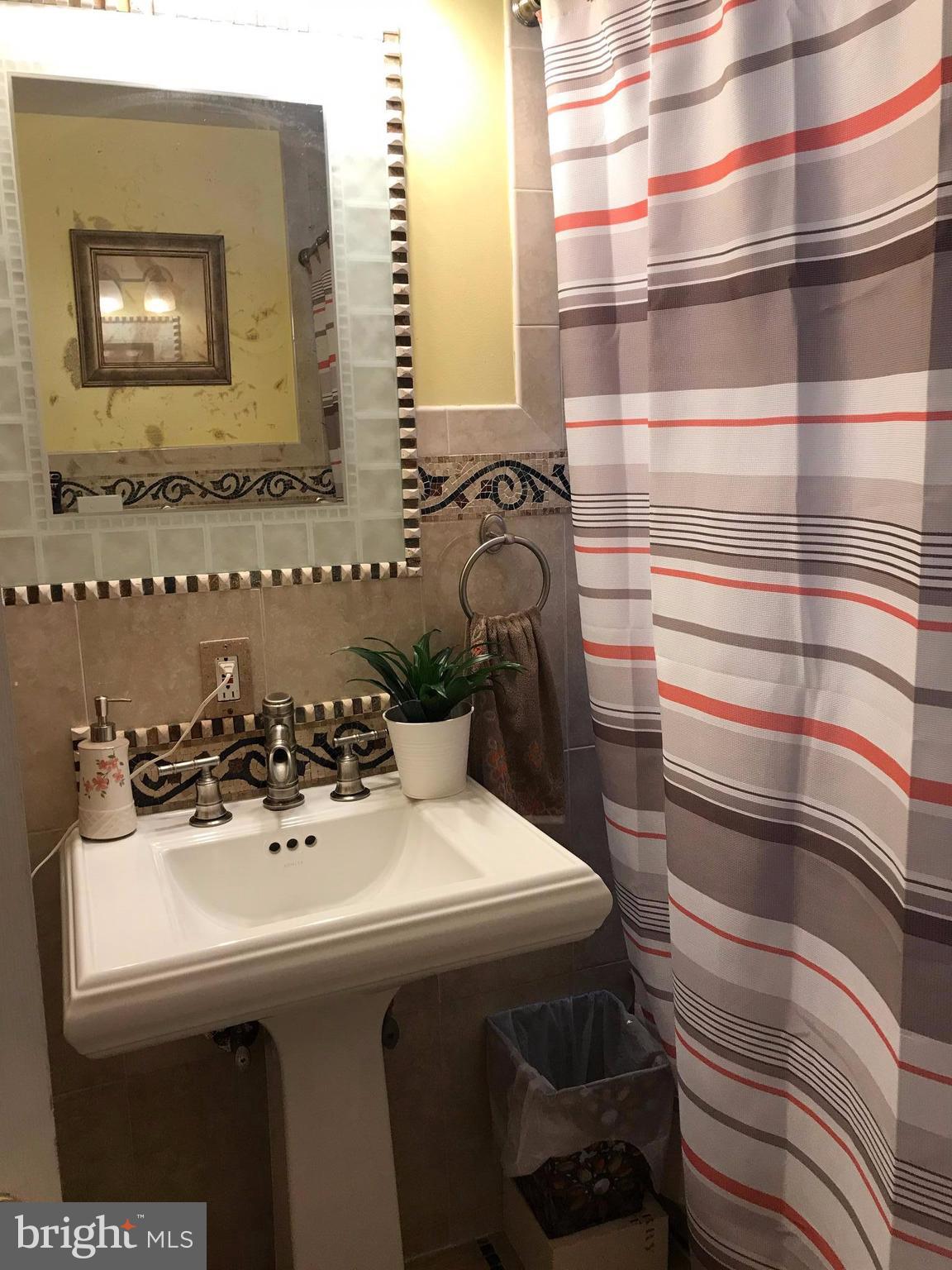 2714 Hughes Road Adelphi, MD 20783 - Photo 11 of 15 a bathroom with a sink and a mirror