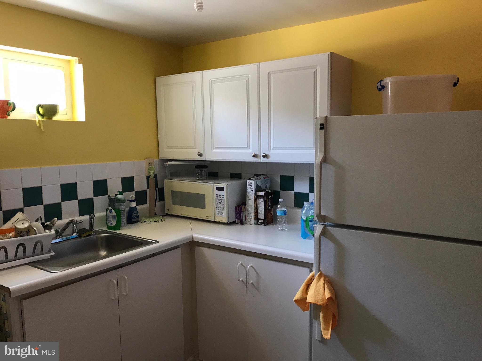 2714 Hughes Road Adelphi, MD 20783 - Photo 13 of 15 a kitchen with a sink and a stove top oven