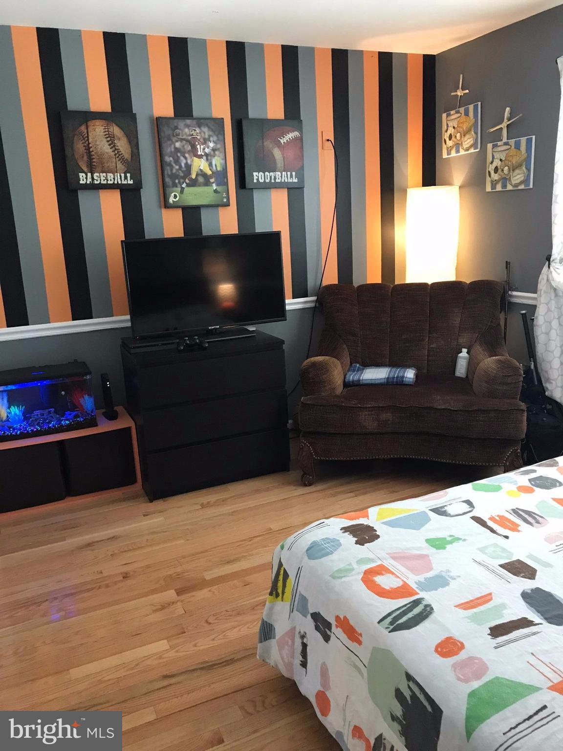 2714 Hughes Road Adelphi, MD 20783 - Photo 5 of 15 a bedroom with a bed and wooden floor