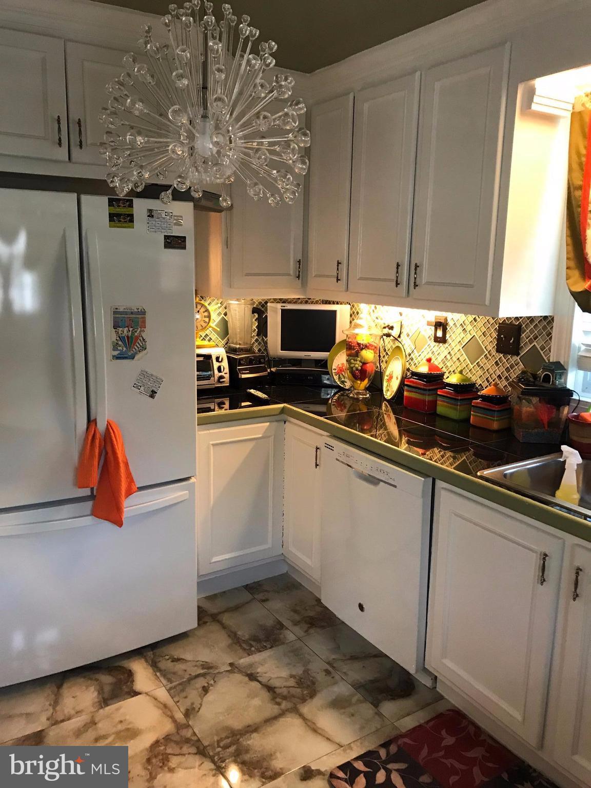 2714 Hughes Road Adelphi, MD 20783 - Photo 9 of 15 a kitchen with stainless steel appliances granite countertop a sink a stove and a microwave