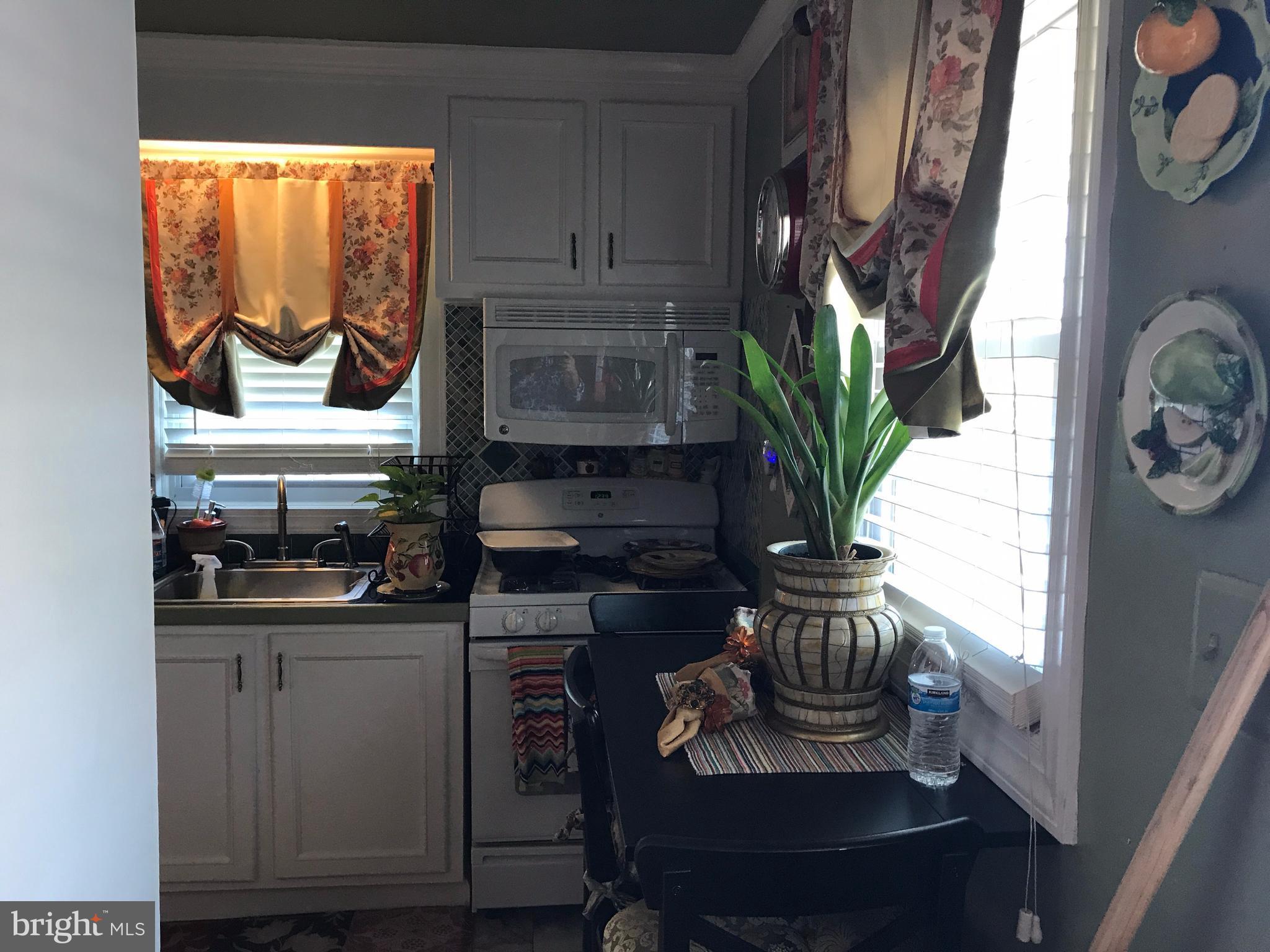 2714 Hughes Road Adelphi, MD 20783 - Photo 10 of 15 a kitchen with a white stove and a window