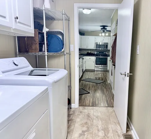 a kitchen with stainless steel appliances kitchen island a stove a refrigerator and cabinets