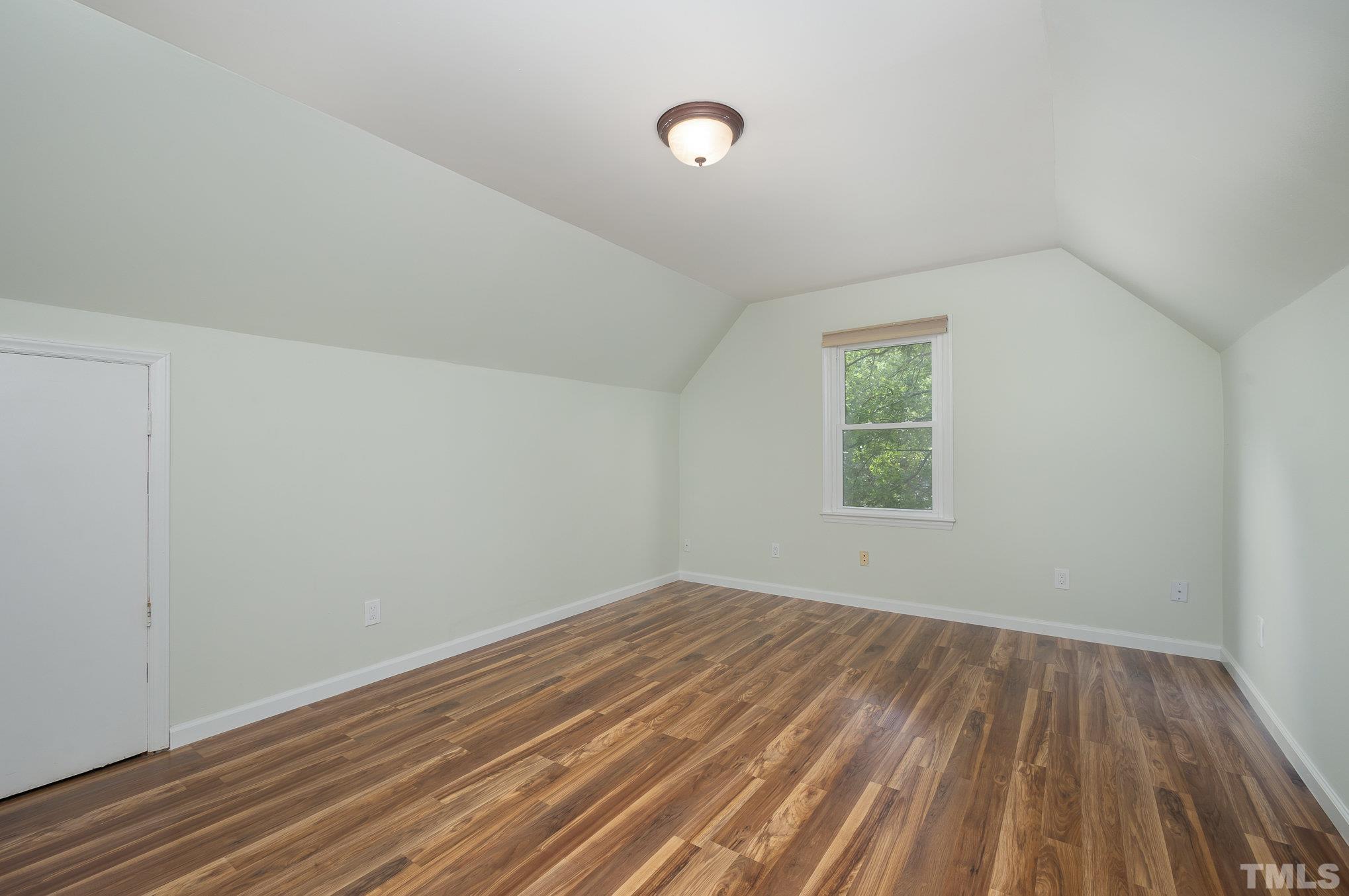 2411 Wade Hampton Road Hillsborough, NC 27278 - Photo 14 of 21 an empty room with wooden floor and windows