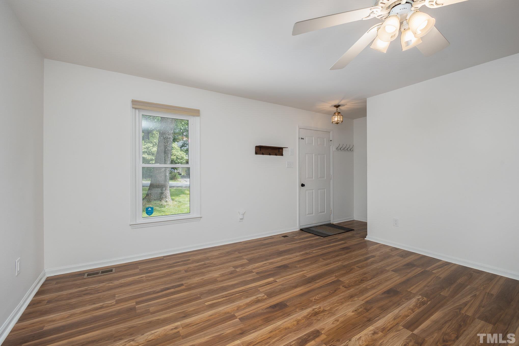 2411 Wade Hampton Road Hillsborough, NC 27278 - Photo 3 of 21 a view of an empty room with wooden floor and a window