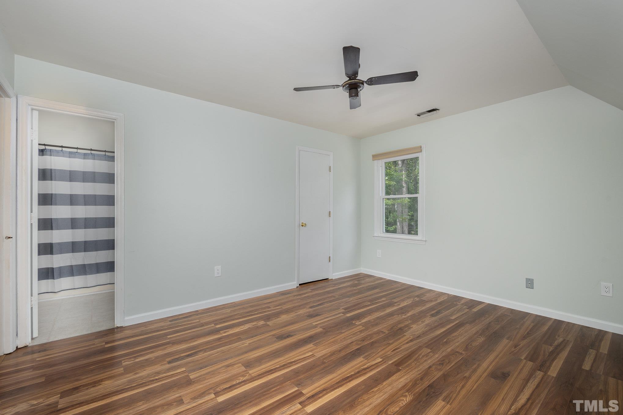 2411 Wade Hampton Road Hillsborough, NC 27278 - Photo 8 of 21 a view of empty room with wooden floor and fan