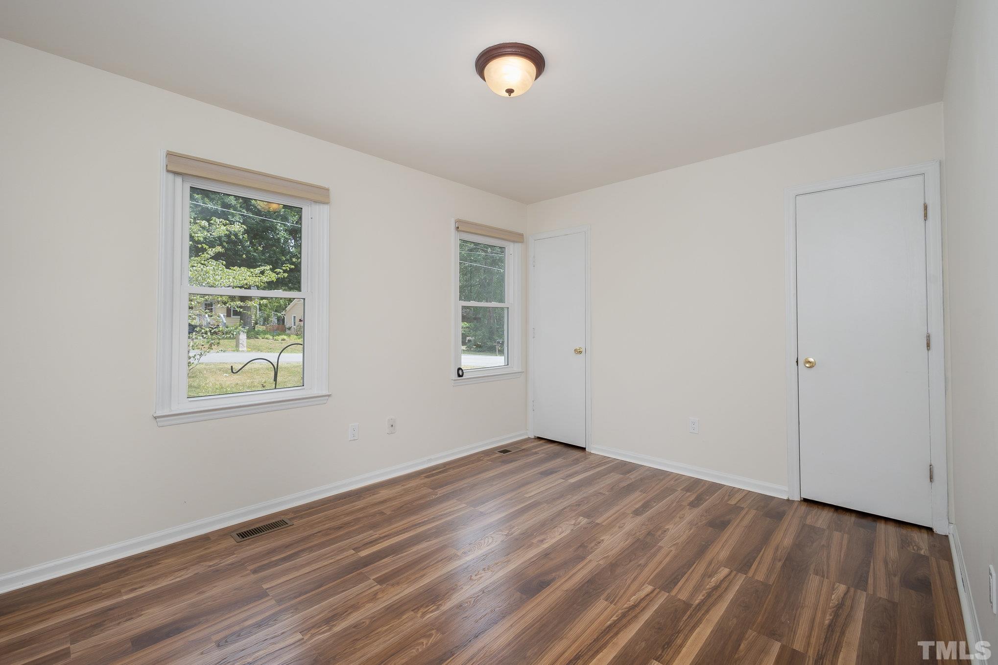 2411 Wade Hampton Road Hillsborough, NC 27278 - Photo 10 of 21 an empty room with wooden floor and windows