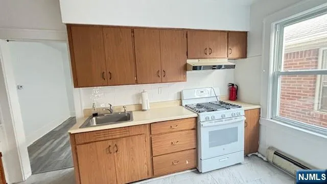 a utility room with sink dryer and washer