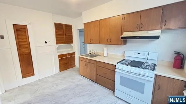 a kitchen with cabinets appliances and a sink