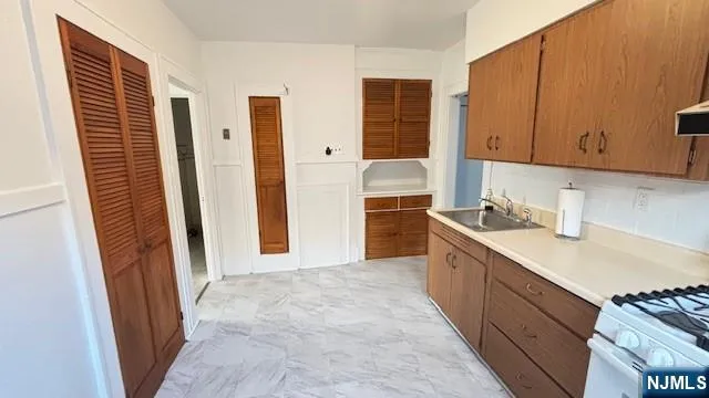 a kitchen with granite countertop a sink and cabinets