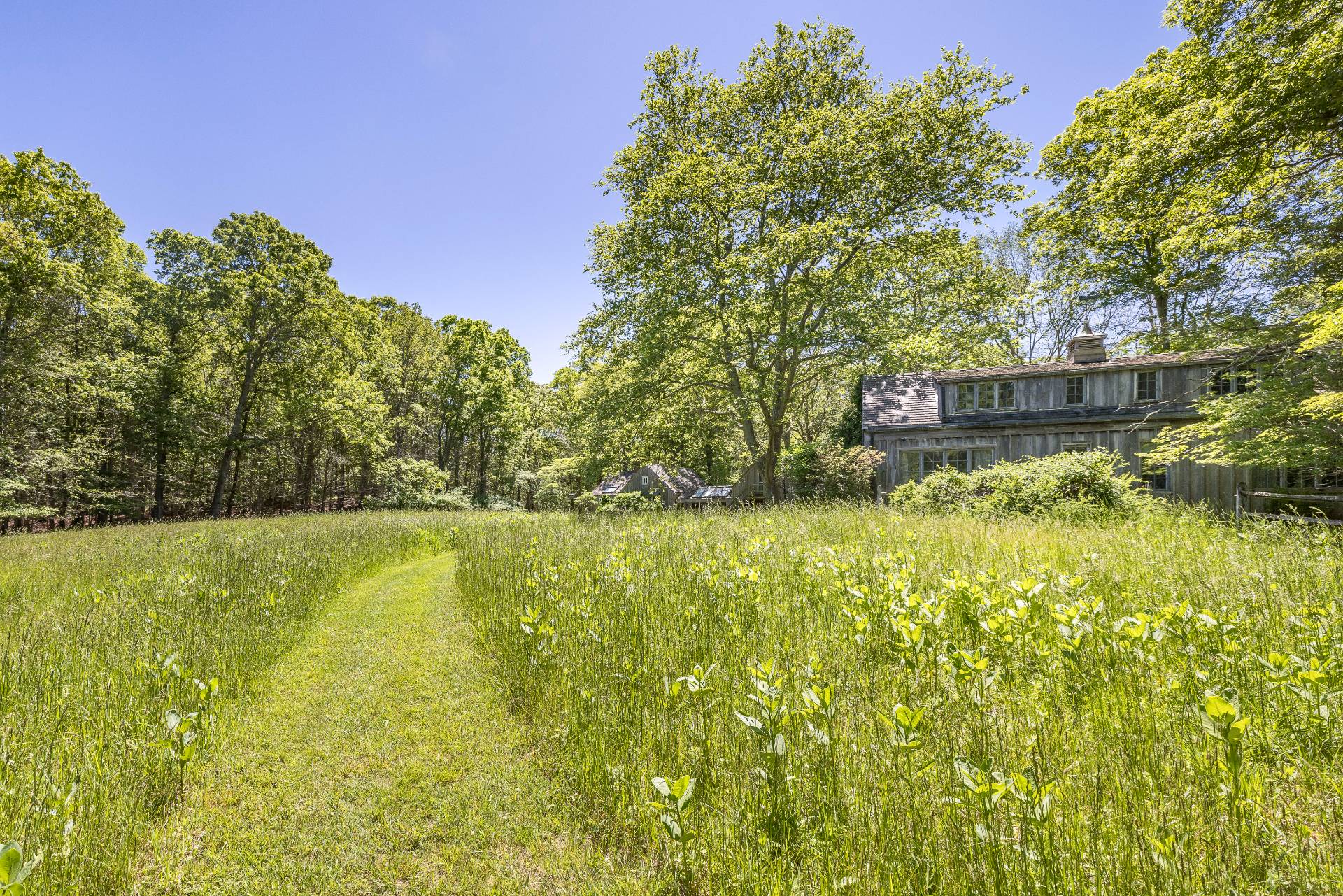 68 Stony Hill Road Amagansett, NY 11930 - Photo 1 of 36 a view of a large body of water with a house in the background