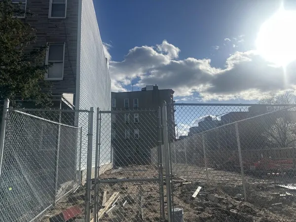 a view of a pathway of a house with a yard