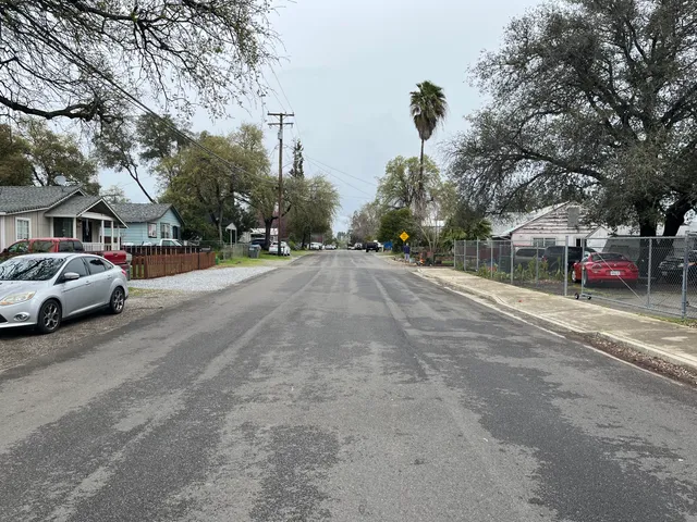 a view of street with parked cars