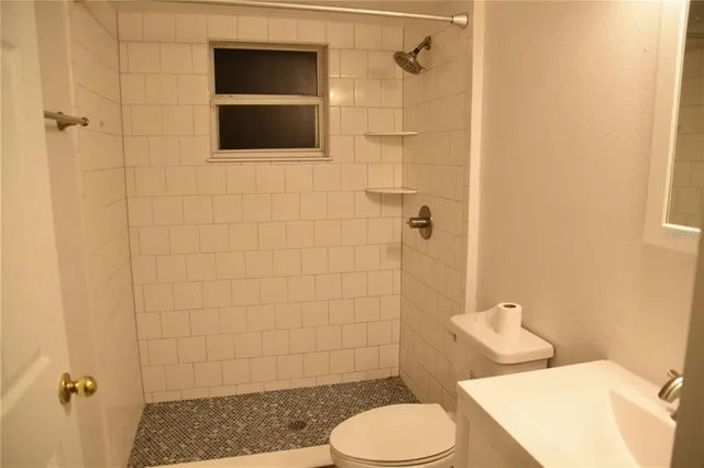 a bathroom with a toilet and a shower