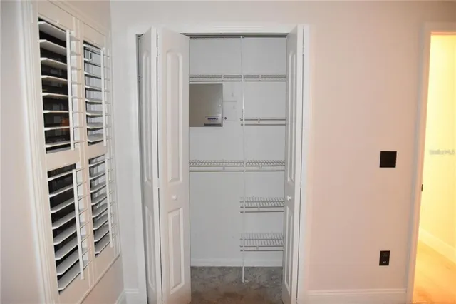 a view of walk in closet with empty racks