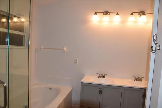 a bathroom with a bathtub and shower