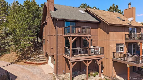 a view of a house with wooden deck