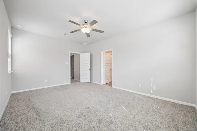 a view of an empty room with a fan