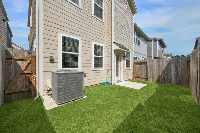 a view of an house with backyard and porch