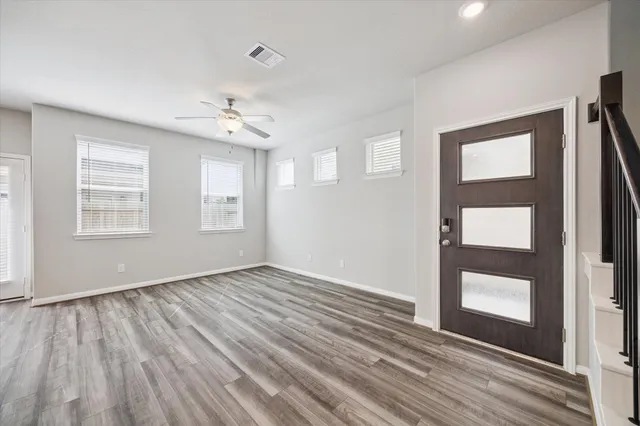 wooden floor in an empty room with a window