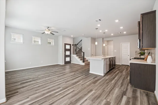 a large kitchen with a large counter top appliances and cabinets