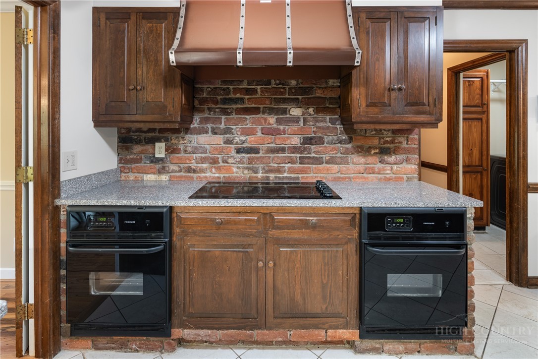 239 Eagle Drive Boone, NC 28607 - Photo 11 of 41 a kitchen with granite countertop a stove and a microwave