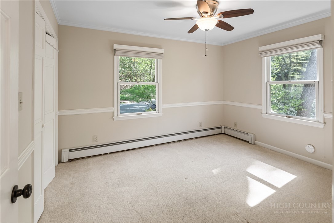 239 Eagle Drive Boone, NC 28607 - Photo 19 of 41 an empty room with a window and a ceiling fan