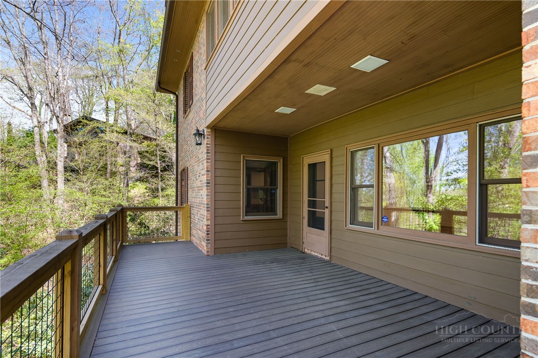 239 Eagle Drive Boone, NC 28607 - Photo 40 of 41 a view of a porch with wooden floor and floor to ceiling window