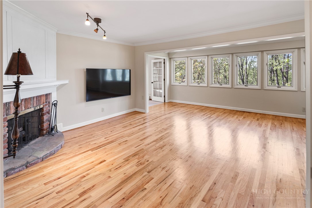 239 Eagle Drive Boone, NC 28607 - Photo 6 of 41 a view of a livingroom with wooden floor and a fireplace