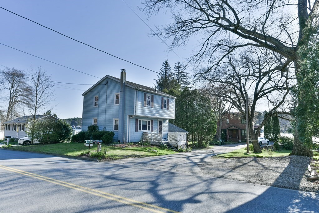 136 Pierpont Road Dudley, MA 01571 - Photo 8 of 28 a front view of a house with a yard and trees