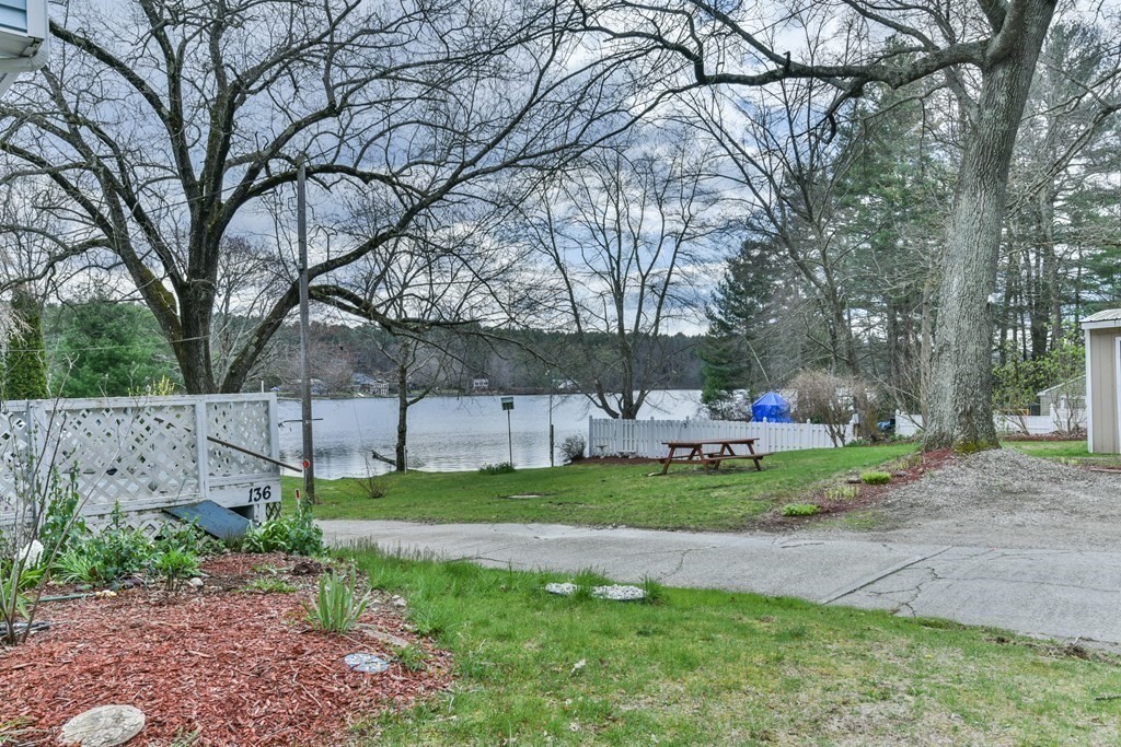 136 Pierpont Road Dudley, MA 01571 - Photo 10 of 28 a front view of a house with a garden and trees