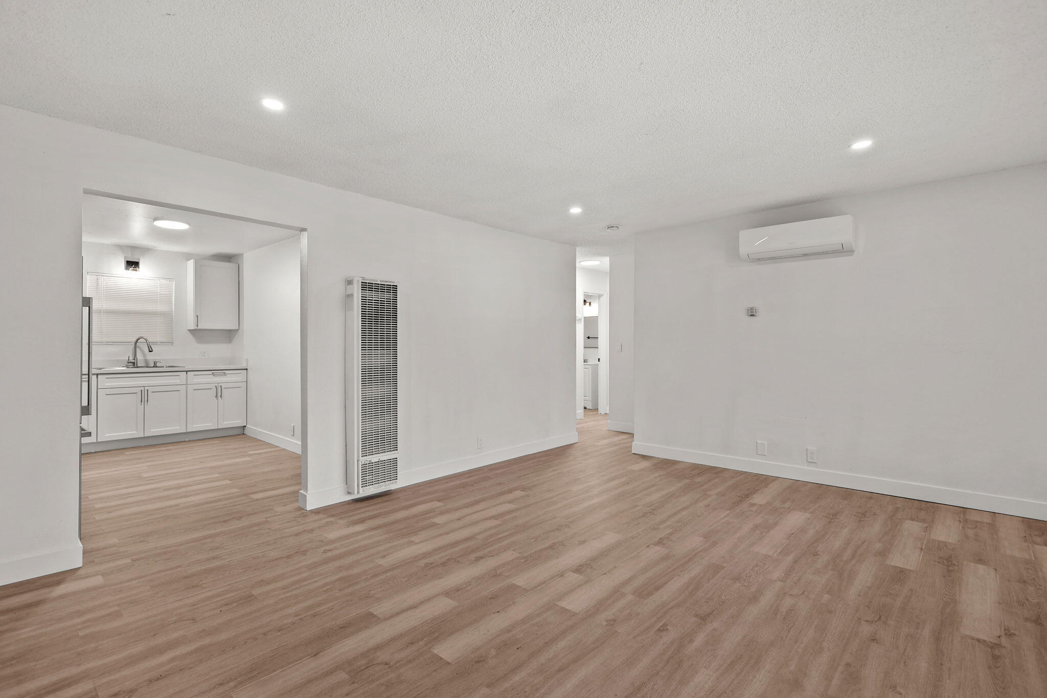 3200 Franklin Street Anderson, CA 96007 - Photo 3 of 35 an empty room with wooden floor and windows