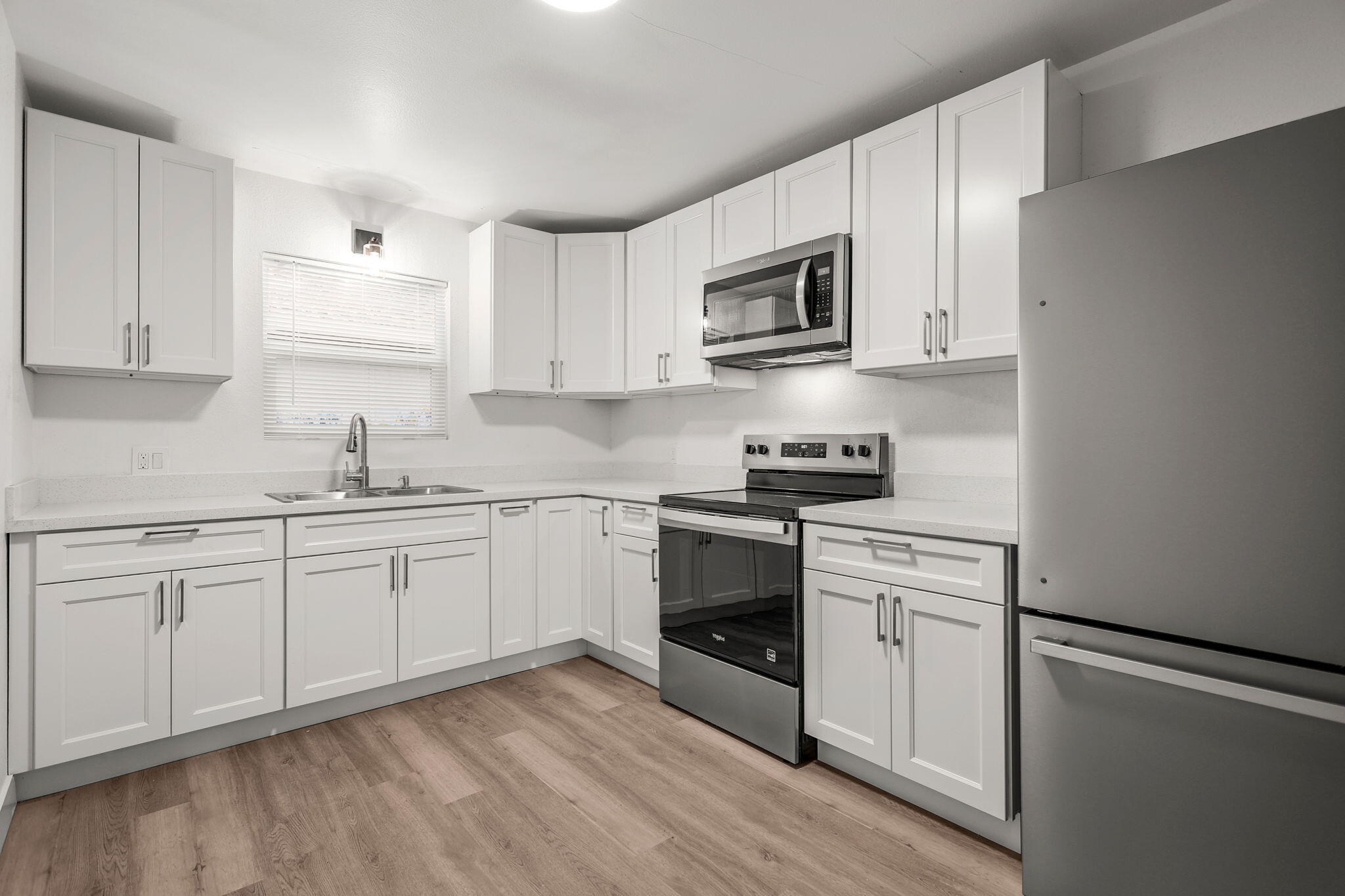 3200 Franklin Street Anderson, CA 96007 - Photo 9 of 35 a kitchen with stainless steel appliances granite countertop white cabinets a sink a stove a microwave and a refrigerator