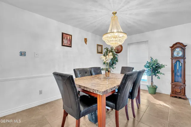 a kitchen with stainless steel appliances granite countertop a refrigerator a stove a sink and white cabinets