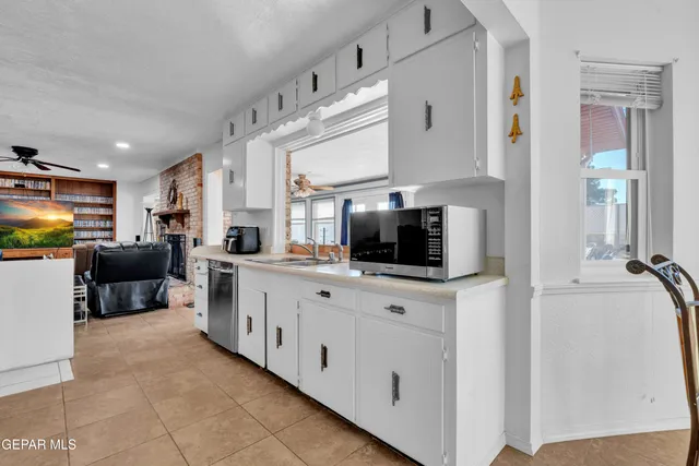 a kitchen with stainless steel appliances a sink and a refrigerator