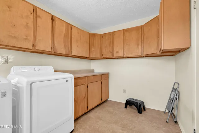a view of a workspace with furniture and gym equipment