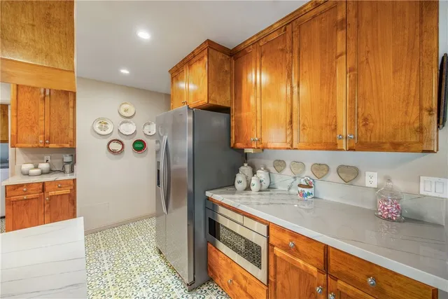 a bathroom with a granite countertop sink and a large mirror