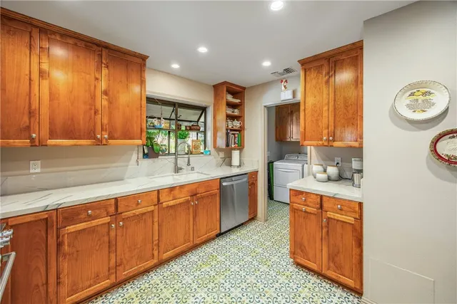 a kitchen with sink cabinets and window